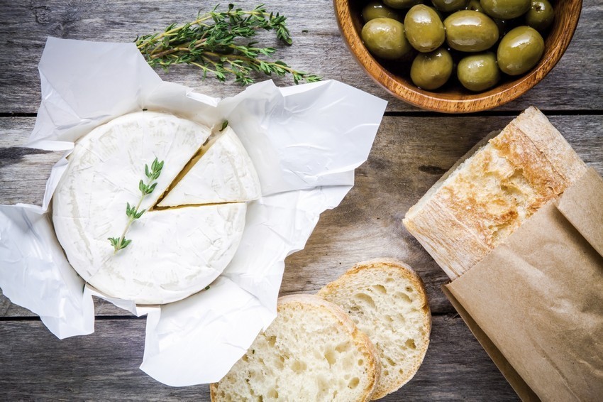 Whole Camembert cheese with thyme