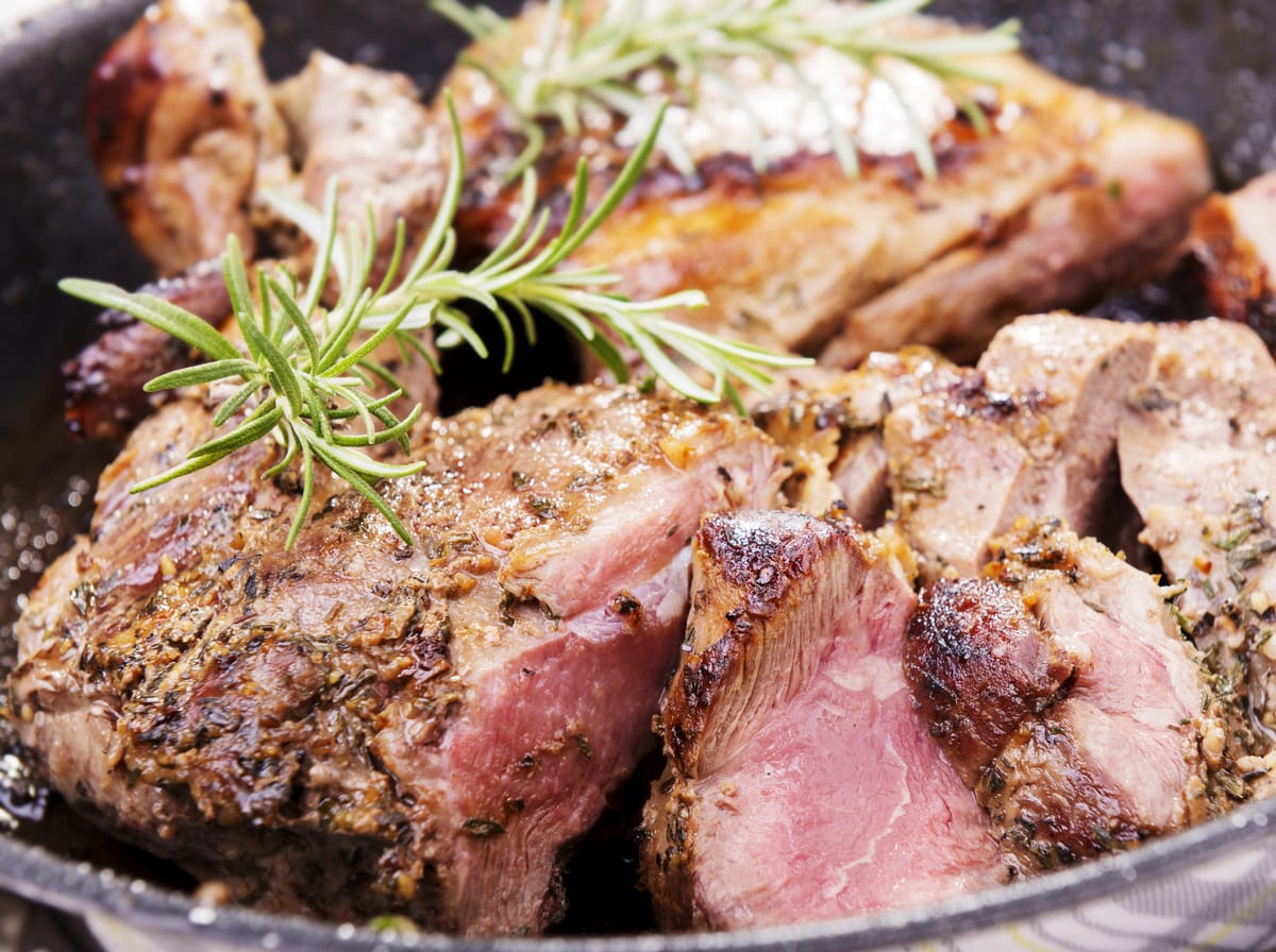 Roasted lamb with rosemary sprigs