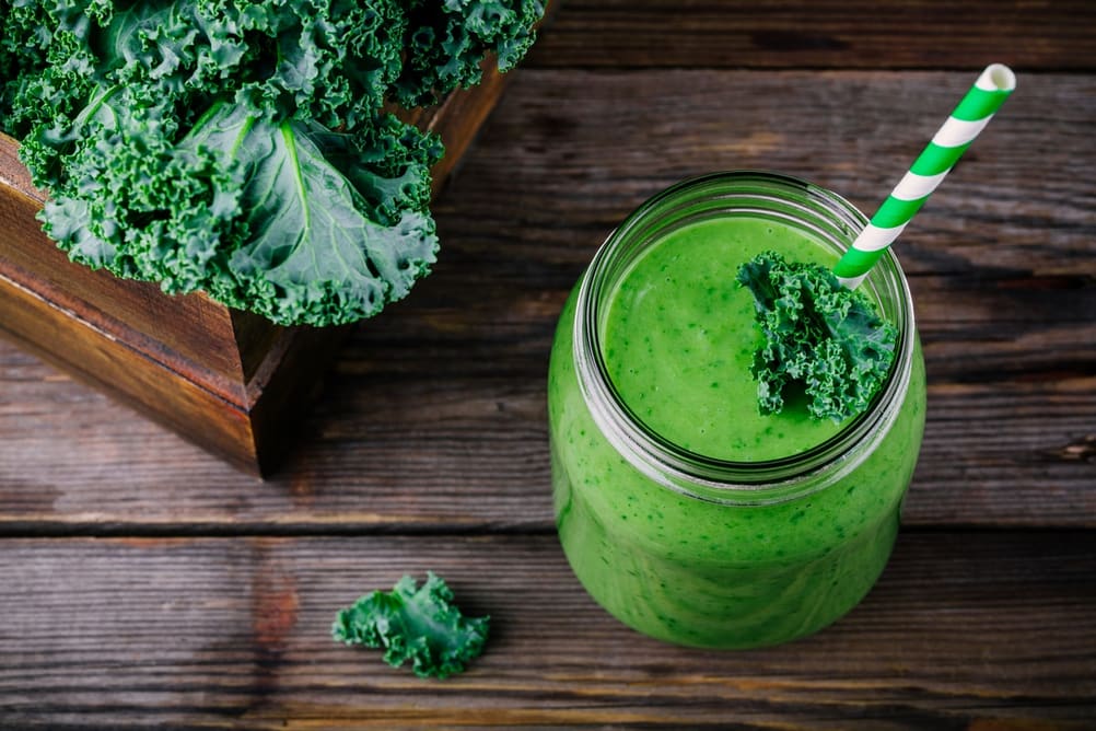 Fresh Kale smoothie with a straw