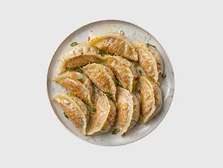 Pan-fried gyoza dumplings arranged on a plate