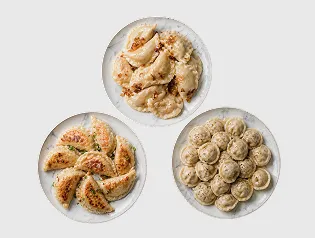Three plates of different cooked dumplings varieties