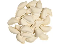 Raw white varenyky dumplings piled together on white background